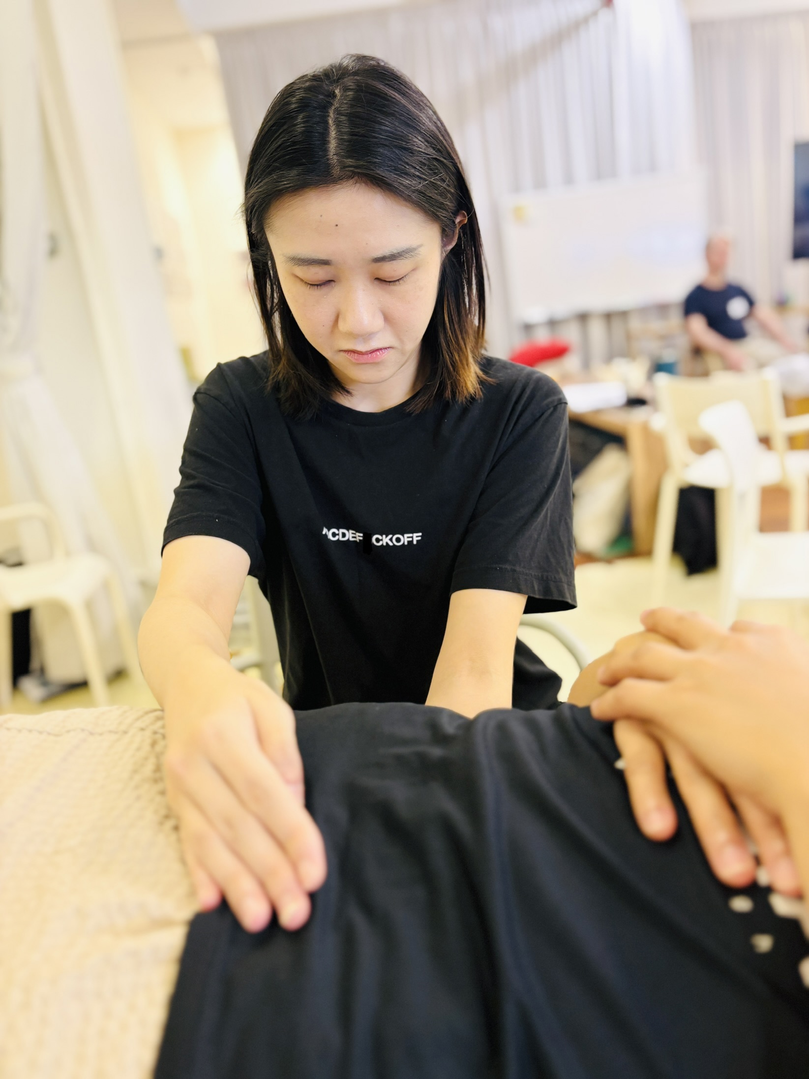 Effy performing CranioSacral Therapy on a client in Singapore